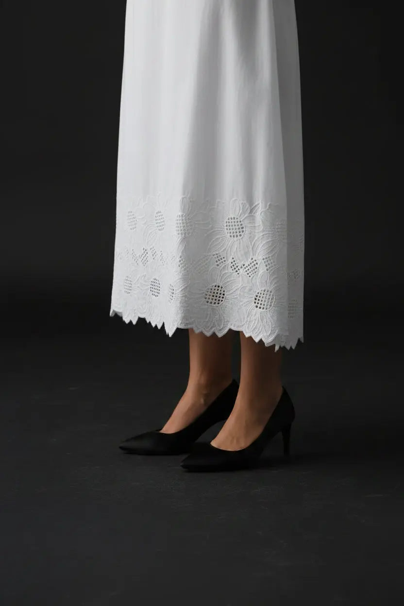 White lace skirt and flats on a white background